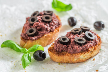 Delicious and healthy bruschetta with black olives as snack.