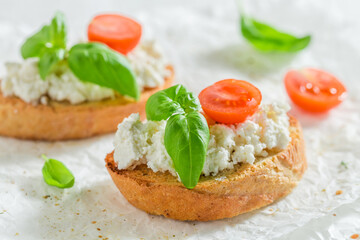 Homemade bruschetta with tomato and ricotta cheese for breakfast.