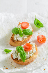 Homemade bruschetta with ricotta cheese and tomato for breakfast.