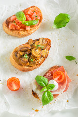 Healthy and delicious various bruschetta with fresh ingredients for breakfast.
