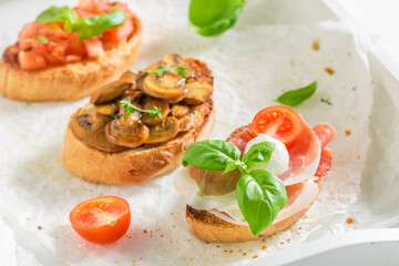 Hot and tasty various bruschetta as classic snack for breakfast.