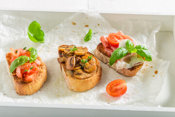 Homemade and aromatic various bruschetta with fresh ingredients for breakfast.