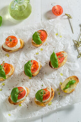 Fresh and tasty crostini with tomatoes, basil and mozzarella