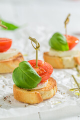 Aromatic and homemade crostini with tomatoes, basil and mozzarella