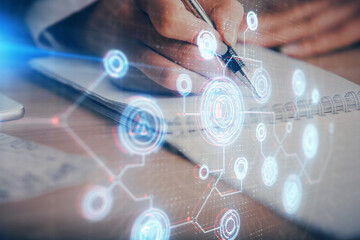 Double exposure of writing hand on background with data technology hologram. Big data concept.