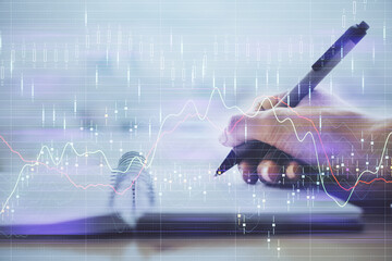 Forex graph on hand taking notes background. Concept of research. Multi exposure