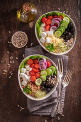 Healthy Greek salad with cheese, olives, cucumber and tomatoes.