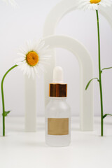 Face serum on a white background. Place for text. Anti aging cosmetics for women. Beautiful 
chamomile flowers and arches in background. Moisturizing essence for skin health.