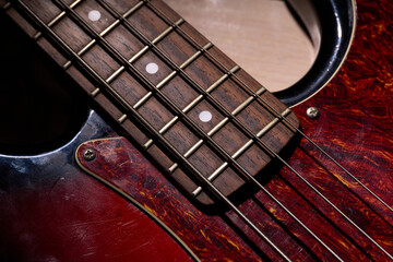 Metallic volume treble guitar bass knobs. Electric guitar. Red electric bass guitar close-up. Musical instrument. Music. Four strings. Grif.