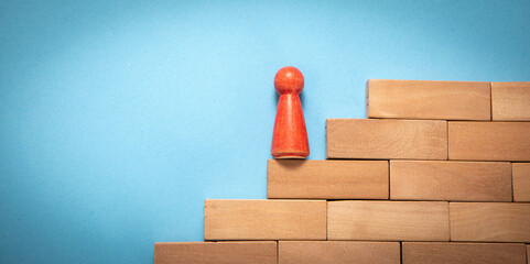 Wooden human figure in the stairs. Business. Career