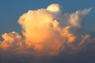 Cumulonimbus large orange cloud in the evening, sunset