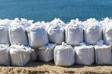 Large sandbags by the sea to prevent flooding