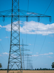 High voltage power lines in a green landscape