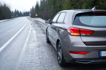 Car on a winter road in the forest. Road Trip Concept.