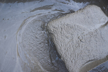 Mixing of cement in a container by a master. High quality photo