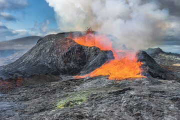 Lava fountains from the volcanic crater in Iceland. Landscape on Reykjanes peninsula in spring with...