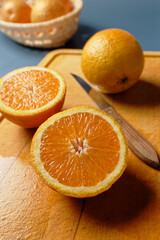 Close up view of halved orange on wooden cutting board