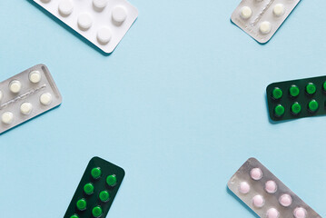 Scattered blisters with pills on a blue background. Model special offers as advertising, web background or other ideas. The concept of medicine, pharmacy and healthcare. copyright.