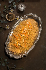 Royal Kabuli Pulao with almond served in dish isolated on dark background top view