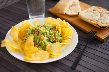 appetizer on a plate. Guacamole with chips
