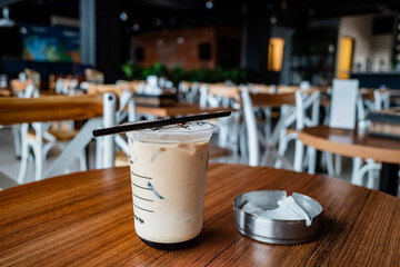 Iced Coffee Served in a Plastic Cup at the Smoking Area of a Café Urban Lifestyle