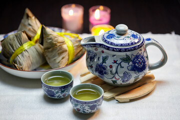 Tea cup with Zongzi on the table