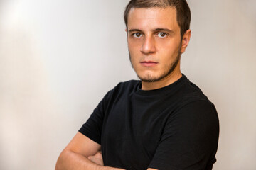 Obraz premium Boy on a white background. Caucasian white man with short hair, little beard and dark eyes.