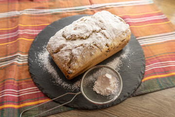 Fruitcake Loaf cake on a black plate. food concept
