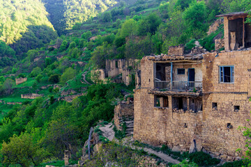 abandoned houses on a mountainside in the ghost village of Gamsutl in Dagestan