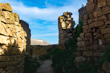 former street among the ruins in the abandoned mountain village of gamsutl in Dagestan