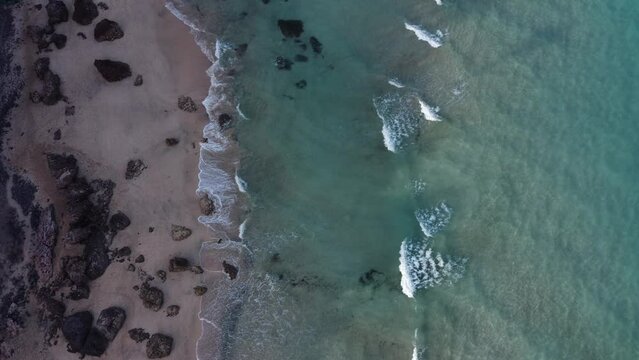 Waves and beach, aerial view in Fuerteventura during sunset