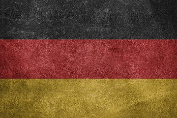 Old leather shabby background in colors of national flag. Germany