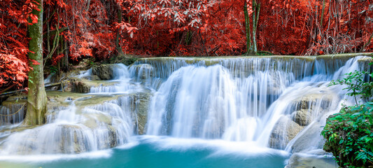 Amazing in nature, beautiful waterfall at colorful autumn forest in fall season	
