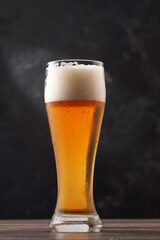 Glass of beer on black background.