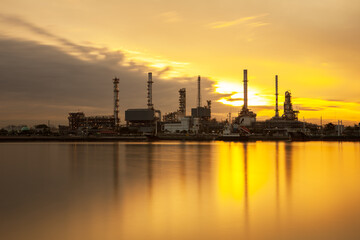 Fototapeta na wymiar Oil refinery with sunset background