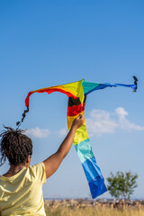 African American woman with a kite in the field.