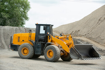 Obraz na płótnie Canvas Sand loaders are shoveling rocks into dump trucks.