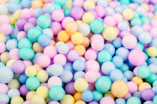 Foam beads of various colors brightly colored background. © gamjai
