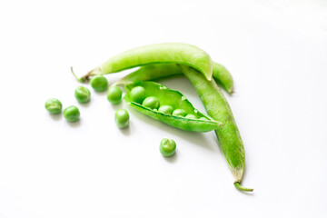fresh whole peas and open pod with fruits on isolated background