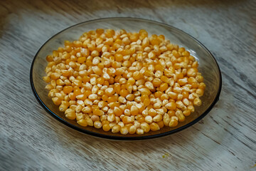 plate full of corn yellow popcorn base, peeled yellow corn