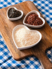 long basmati rice white and black set of three heart-shaped plate close up