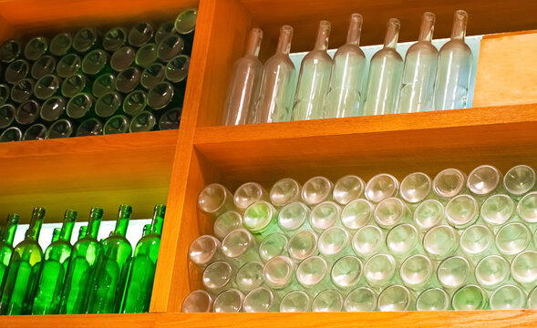 set of glass bottles of various stands on a wooden shelf, cafe decoration design