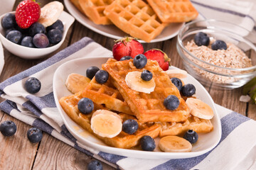 Waffles with blueberries, bananas and honey.