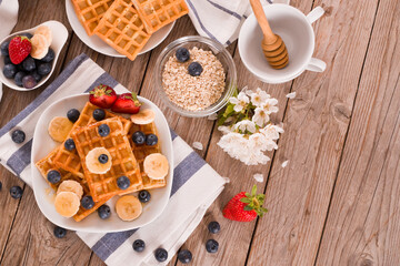 Waffles with blueberries, bananas and honey.