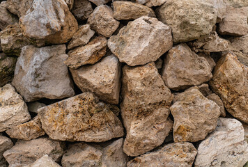 stone texture of brown cobblestones uneven and weathered close-up