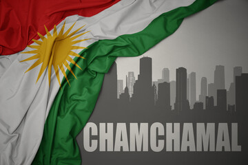 abstract silhouette of the city with text Chamchamal near waving national flag of kurdistan on a gray background.3D illustration