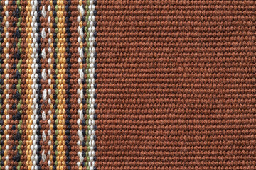 Brown textile background with copy space. Plain weave fabric with vertical stripes of white,...