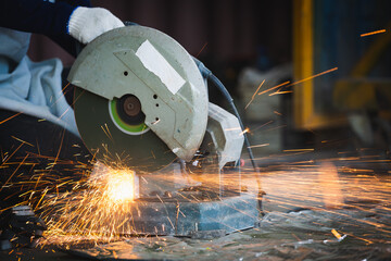Cutting of a steel with splashes of sparks at construction site.