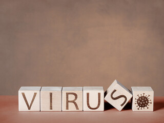 VIRUS text written on wooden blocks as a concept of the viral epidemic