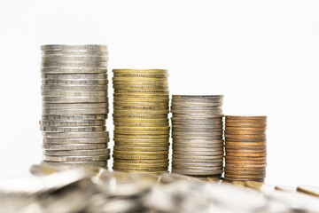 Pile of coins in white background close-up arranged in a row